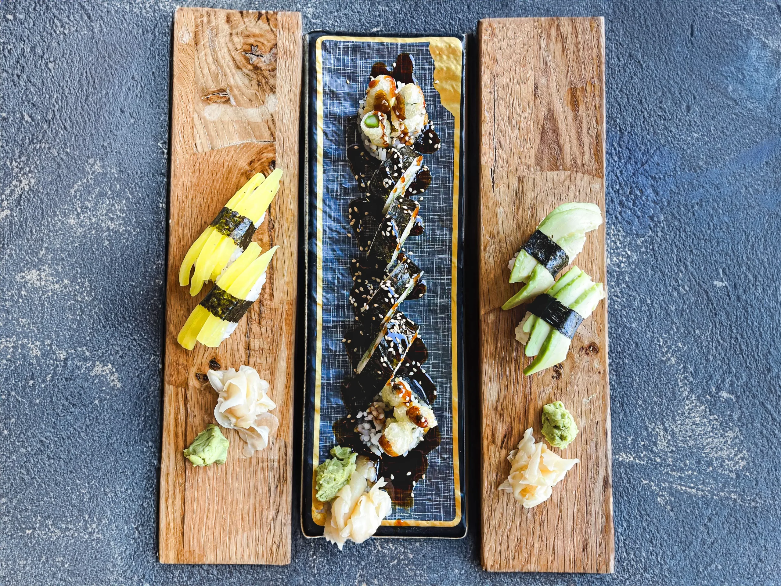 Assorted sushi platter with nigiri and grilled eel roll, garnished with wasabi and ginger at Sushi Hana, a Sushi restaurant in Boulder